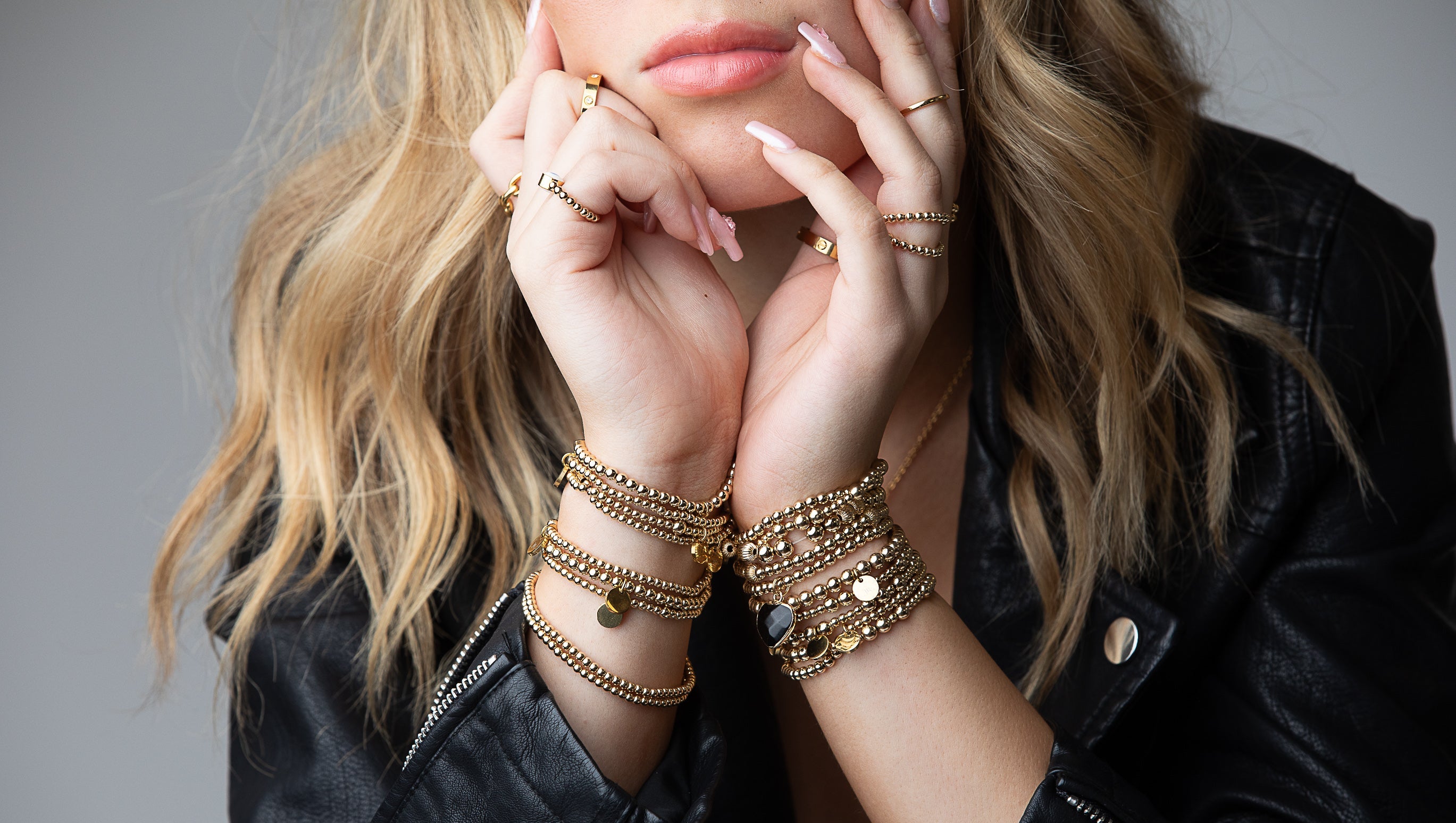 Model wearing several J.Rose Design Beaded Bracelets.